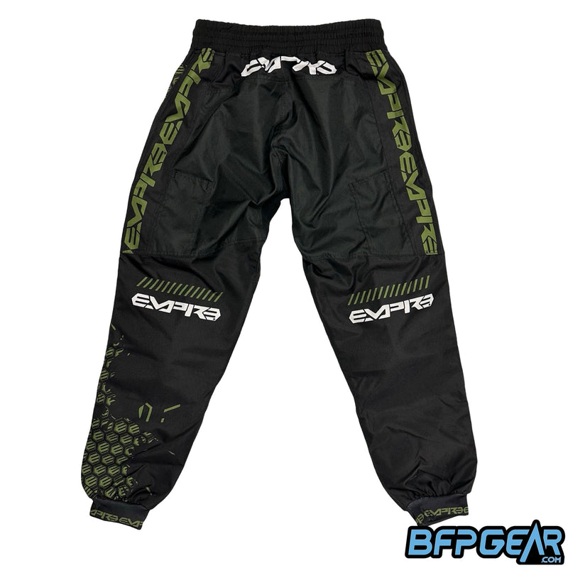 The back of the Empire Classic Pant in the Black and Olive color way. The Empire test logo is along side the top of the legs, with Empire just under the back of the knee.