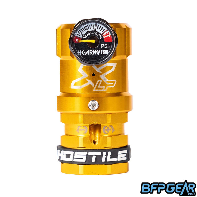 The Hostile XLP Regulator in gold - side feed. This regulator helps turn the output pressure down so you can use it for your airsoft HPA setup.