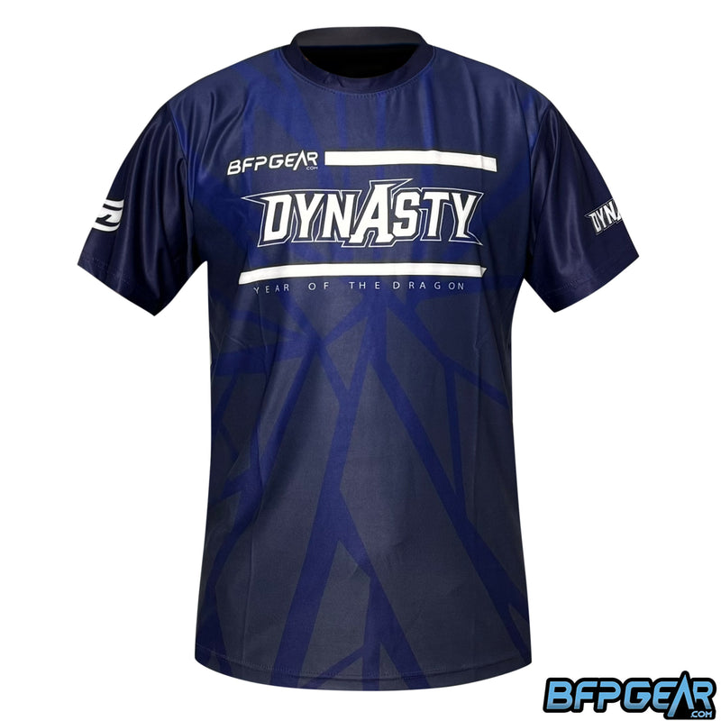 This shirt has a cracked glass pattern that is dark blue and grey, has the Dynasty logo on the front, and says YEAR OF THE DRAGON underneath.