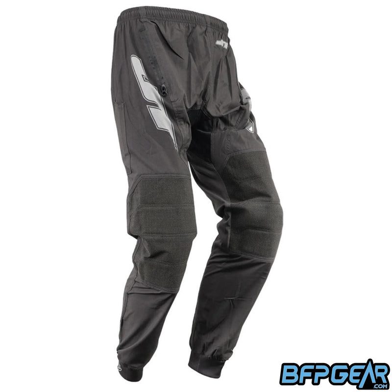 The JT Team Jogger paintball pants in black. These pants are all black with grey JT logos along the outer thighs. Kevlar-reinforced knee material helps with durability under harsh conditions.