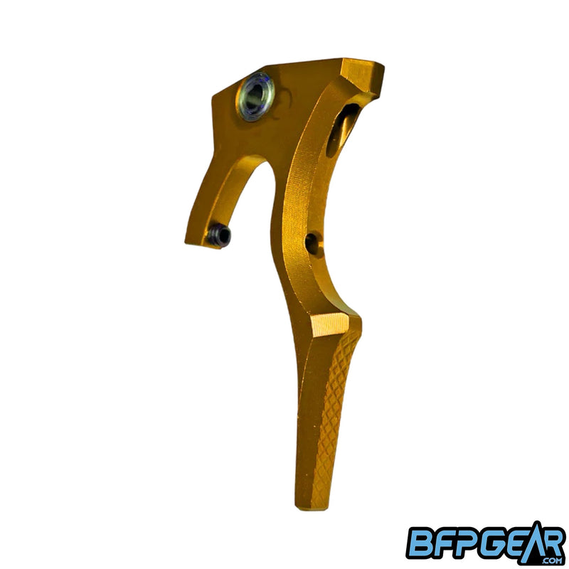 The Luxe IDOL Haptic Deuce trigger by Infamous Paintball. Color way is gold.